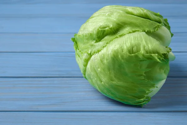 Fresh ripe cabbage on color wooden table