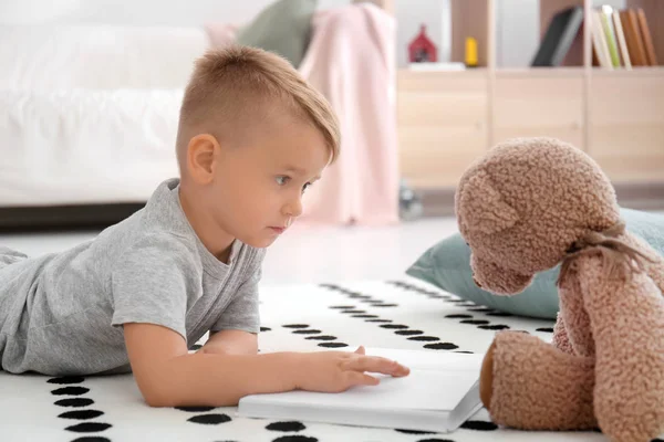 Cute Little Boy Teddy Bear Reading Book Floor Home — Stock Photo, Image