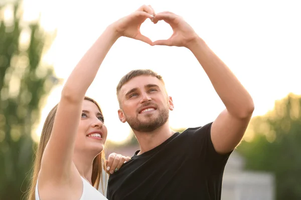 Happy Couple Making Heart Hands Outdoors — Stock Photo, Image