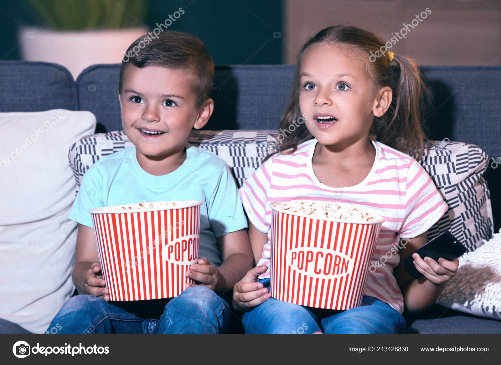 children-eating-popcorn-while-watching-evening-stock-photo-by-serezniy