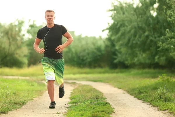 Sporty Young Man Running Outdoors — Stock Photo, Image