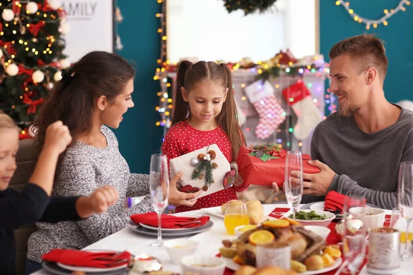 Little Girl Receiving Gifts Her Parents Christmas Dinner — Stock Photo, Image