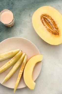 Dilimler ve renk arka plan üzerinde olgunlaşmış kavun yarısı ile plaka