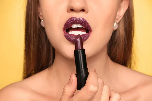 Beautiful Young Woman Applying Dark Lipstick Color Background Closeup — Stock Photo, Image