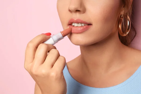 Beautiful Young Woman Applying Pink Lipstick Color Background Closeup — Stock Photo, Image