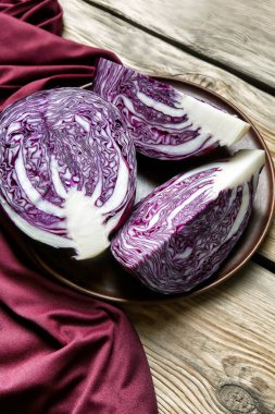 Ahşap masa üzerinde olgun kırmızı lahana ile plaka