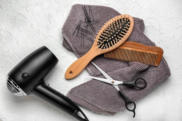 Professional hairdresser\'s tools with hair dryer on light background