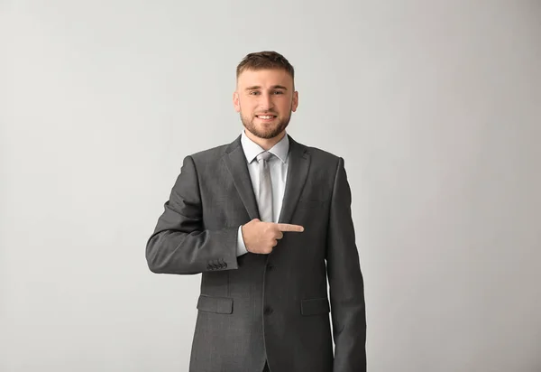 Handsome Businessman Pointing Something Grey Background — Stock Photo, Image