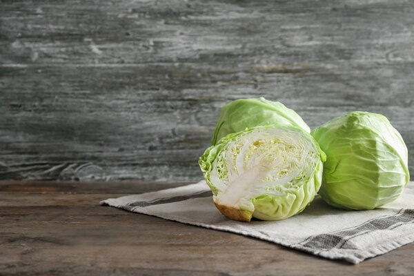 Fresh cabbages on wooden table