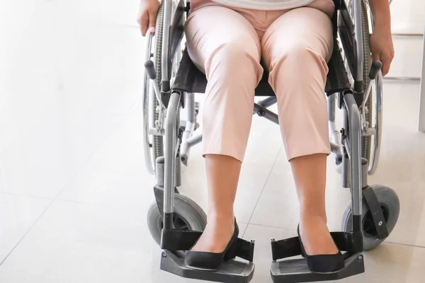 Asian woman in wheelchair in office