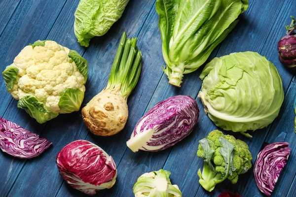 Different types of cabbage on color wooden background — Stock Image Different Types Cabbage Color Wooden Background Stock Image