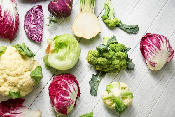 Different types of cabbage on light wooden background — Stock Image Different Types Cabbage Light Wooden Background Royalty Free Stock Photos