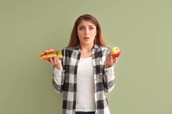 Young Woman Choosing Croissant Apple Color Background — Stock Photo, Image