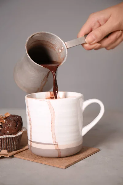 Frau Gießt Heiße Schokolade Aus Cezve Tasse Auf Grauem Tisch — Stockfoto