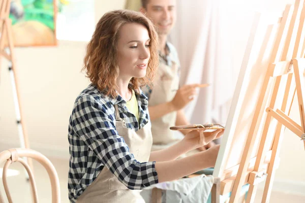 Female student during classes in school of painters