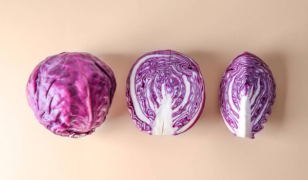 Cut red cabbage on color background