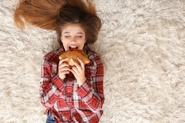 Woman Eating Tasty Croissant Floor Home — Stock Photo, Image