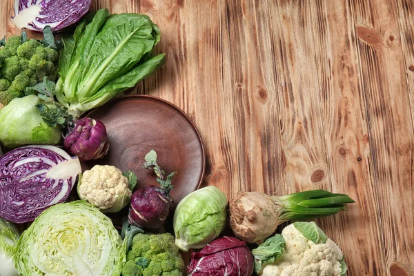 Different types of cabbage on wooden background — Stock Image Different Types Cabbage Wooden Background Royalty Free Stock Images