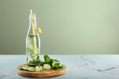 Masaya bir şişe salatalık doldurulmuş su.