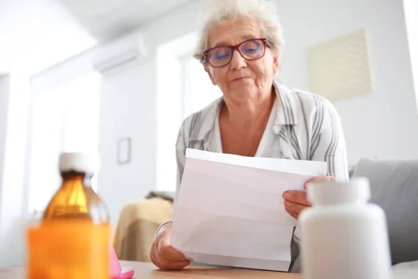 Seniorin Liest Anleitung Bevor Sie Medikamente Hause Einnimmt — Stockfoto