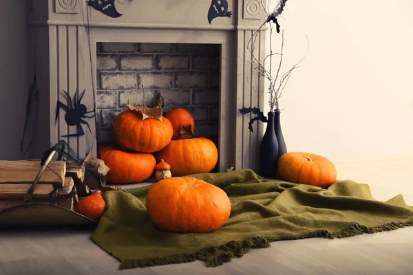 Pumpkins near fireplace decorated for Halloween