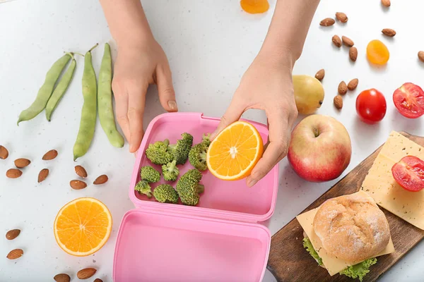 Mother Putting Food Schoolchild Lunch Box Table — Stock Photo, Image