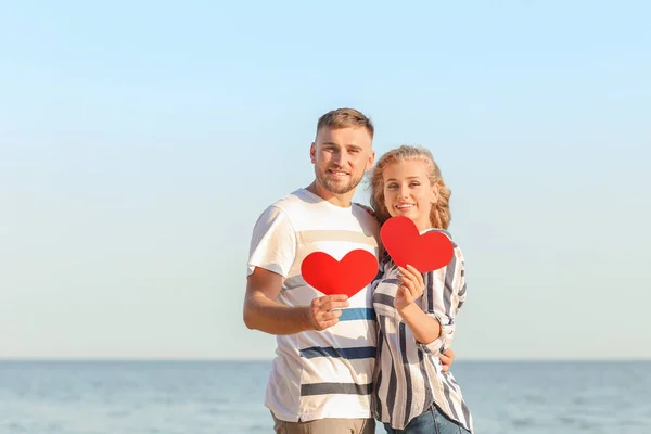 Cute Young Couple Holding Red Hearts Sea Shore — Stock Photo, Image