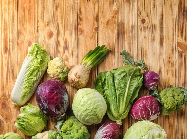 Different types of cabbage on wooden background — Stock Image Different Types Cabbage Wooden Background Royalty Free Stock Photos