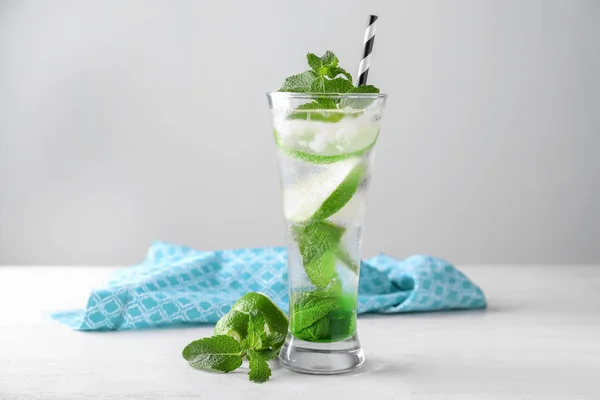 Glass of fresh mojito on light table