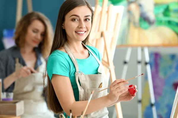 Female student during classes in school of painters