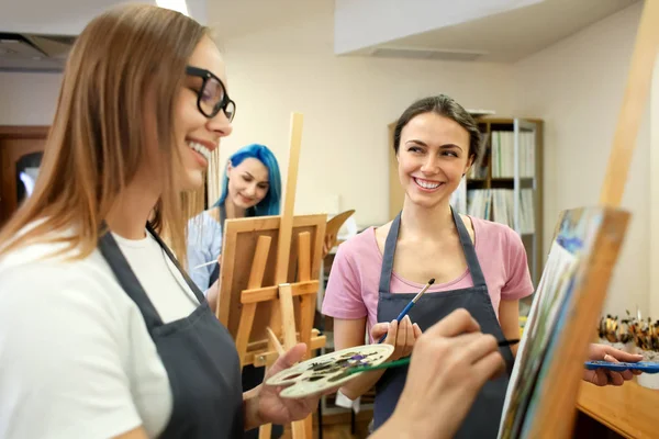 Art students painting in workshop