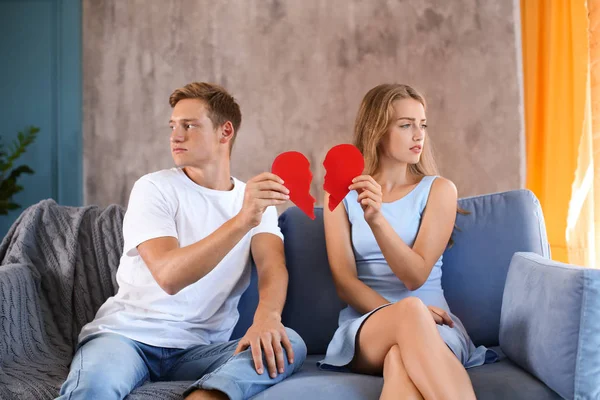 Young Couple Holding Halves Broken Heart Sofa Home Relationship Problems — Stock Photo, Image