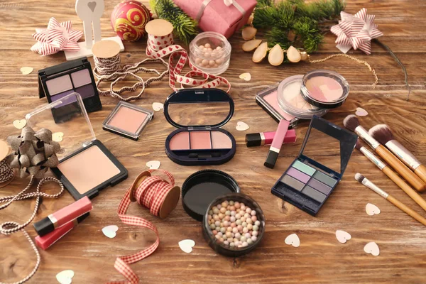 Set of cosmetics with decor for Christmas gifts on wooden table