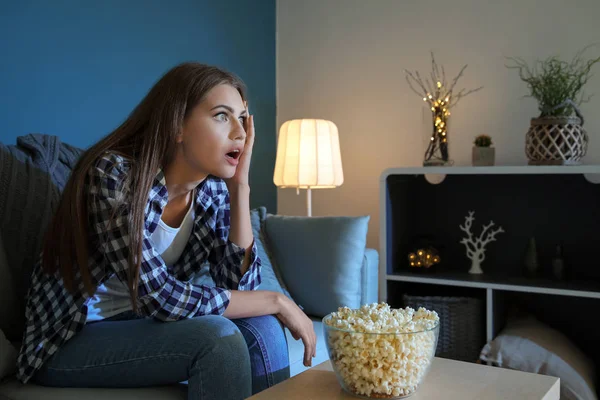 Emotional Young Woman Eating Popcorn While Watching Late Evening — Stock Photo, Image