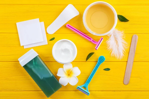 Set for hair removing on color wooden background