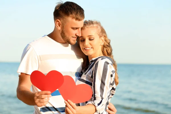 Cute Young Couple Holding Red Hearts Sea Shore — Stock Photo, Image