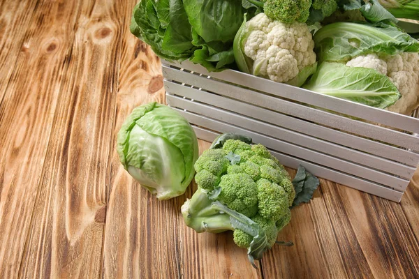 Crate with different types of cabbage on wooden background — Stock Image Crate Different Types Cabbage Wooden Background Stock Photo
