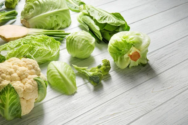 Different types of cabbage on light wooden background — Stock Image Different Types Cabbage Light Wooden Background Stock Image