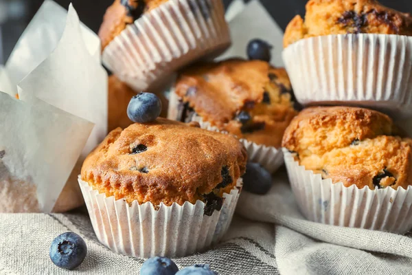 Tasty blueberry muffins on napkin, closeup