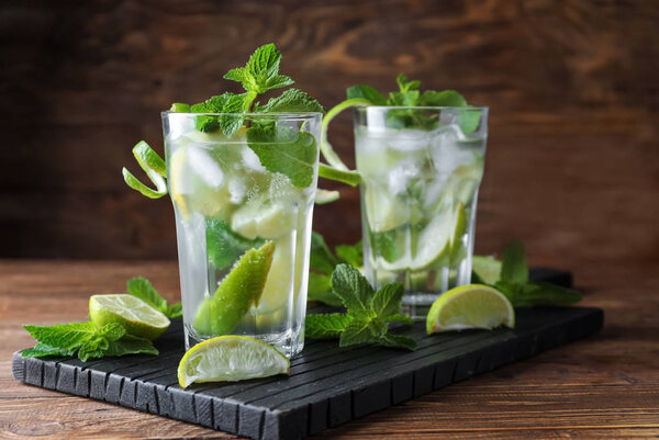 Fresh mojito in glasses on wooden table