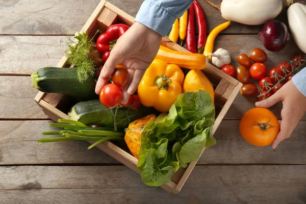 Woman Taking Fresh Vegetables Out Wooden Crate Top View — Stock Photo, Image