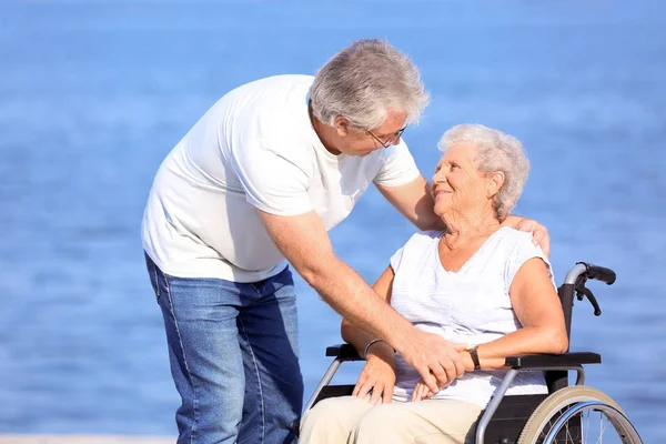 Senior Woman Wheelchair Her Husband River — Stock Photo, Image