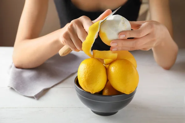Woman Peeling Ripe Lemons White Wooden Table Closeup — Stock Photo, Image