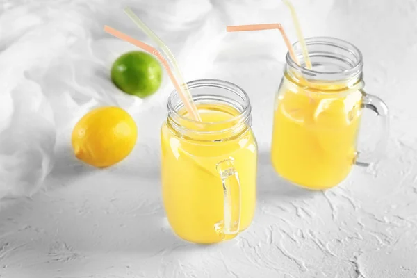 Mason Jars Fresh Lemon Juice White Textured Background — Stock Photo, Image