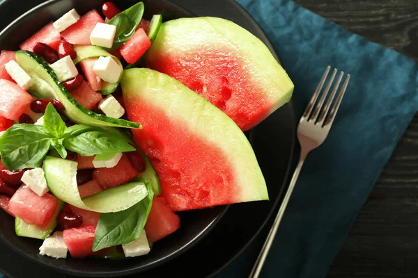 Plate with delicious watermelon salad on table, closeup