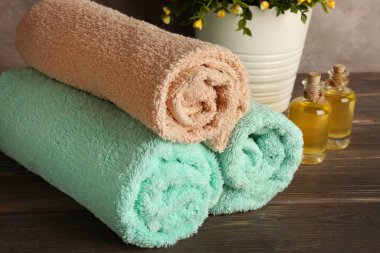 Yumuşak havlu ve ahşap masa üzerinde önemli petrol şişe