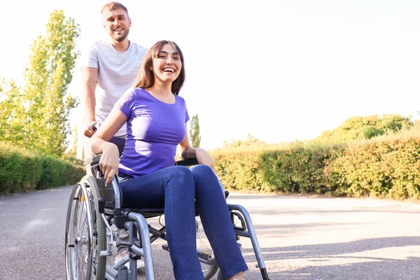 Happy Young Woman Wheelchair Her Husband Outdoors — Stock Photo, Image