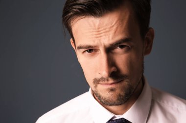 Gri arka planda yakışıklı iş adamı