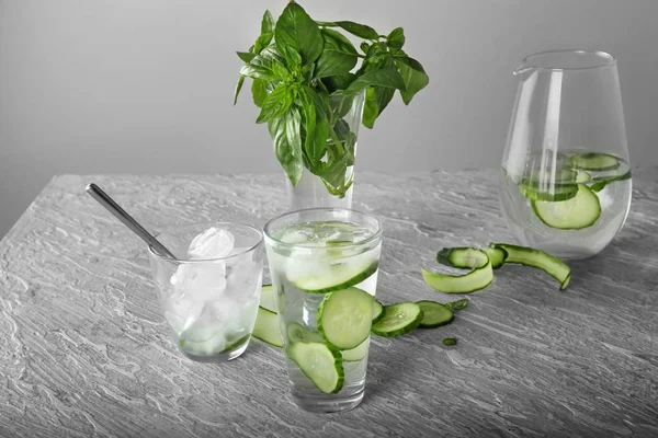 Glassware of fresh cucumber water on light table
