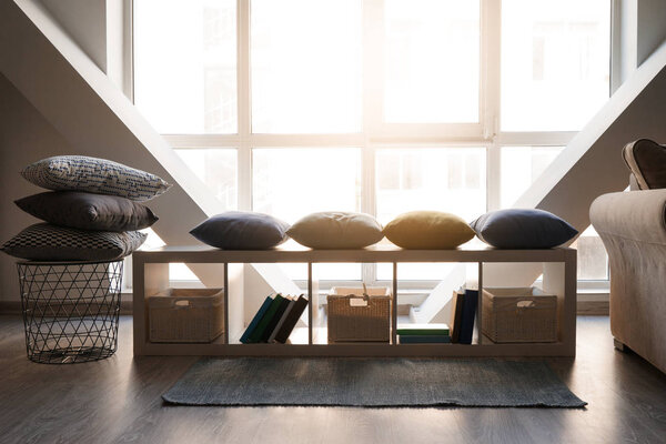 Cozy place for rest with soft pillows near window
